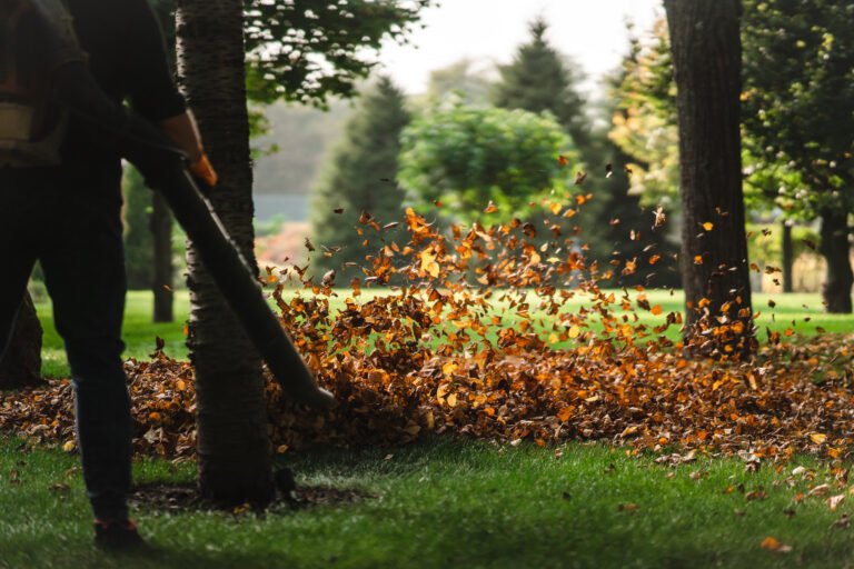 a woman operating a heavy duty leaf blower.